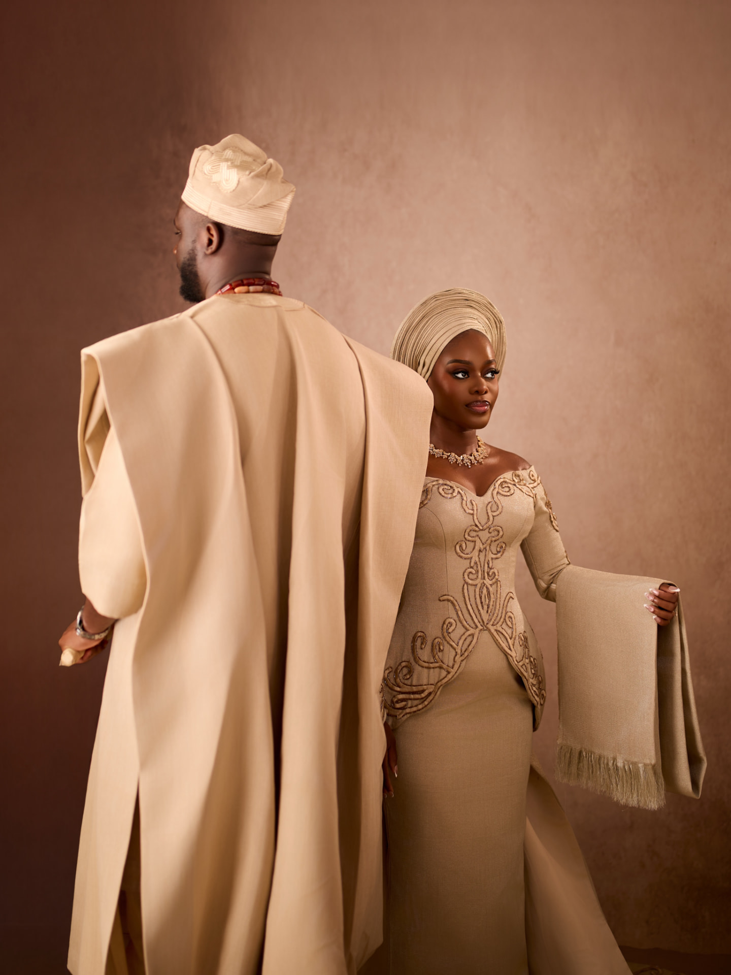 Aso-oke gown with embroidered sweeping train